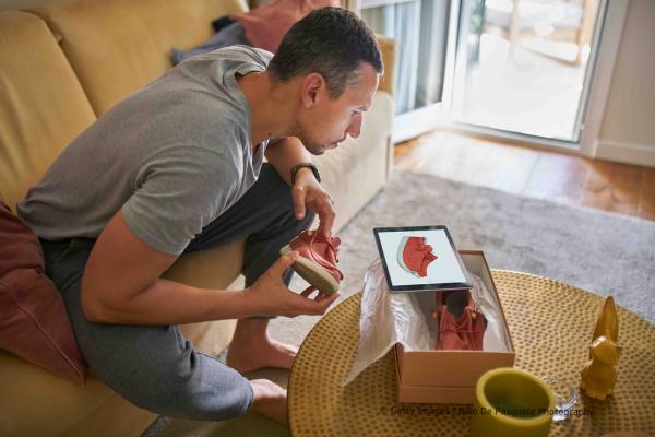 Man checking item bought online and delivered home