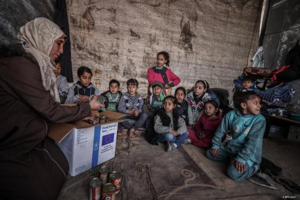 group of small children listening to a teacher in Gaza